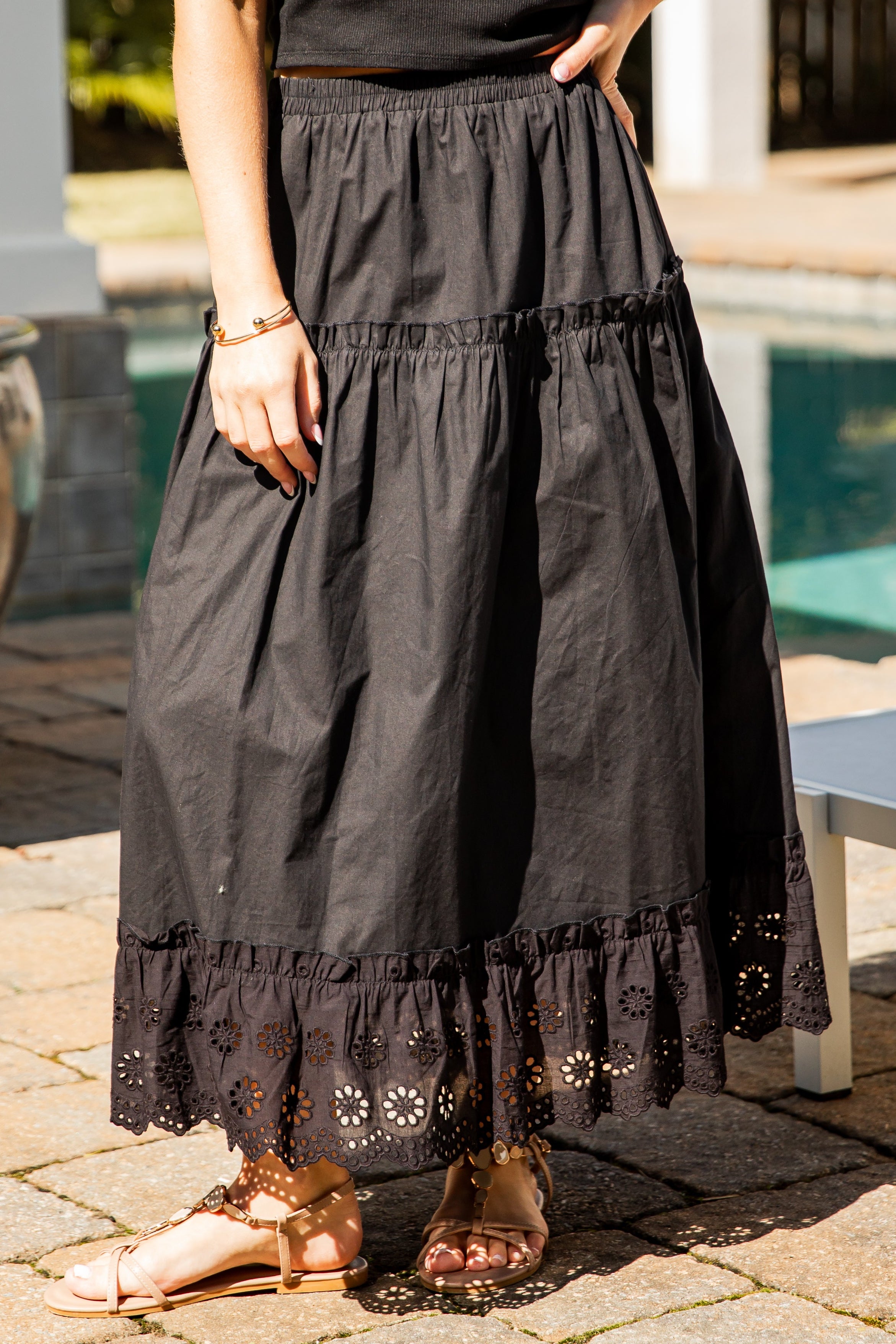 Black lace-trim maxi skirt styled poolside