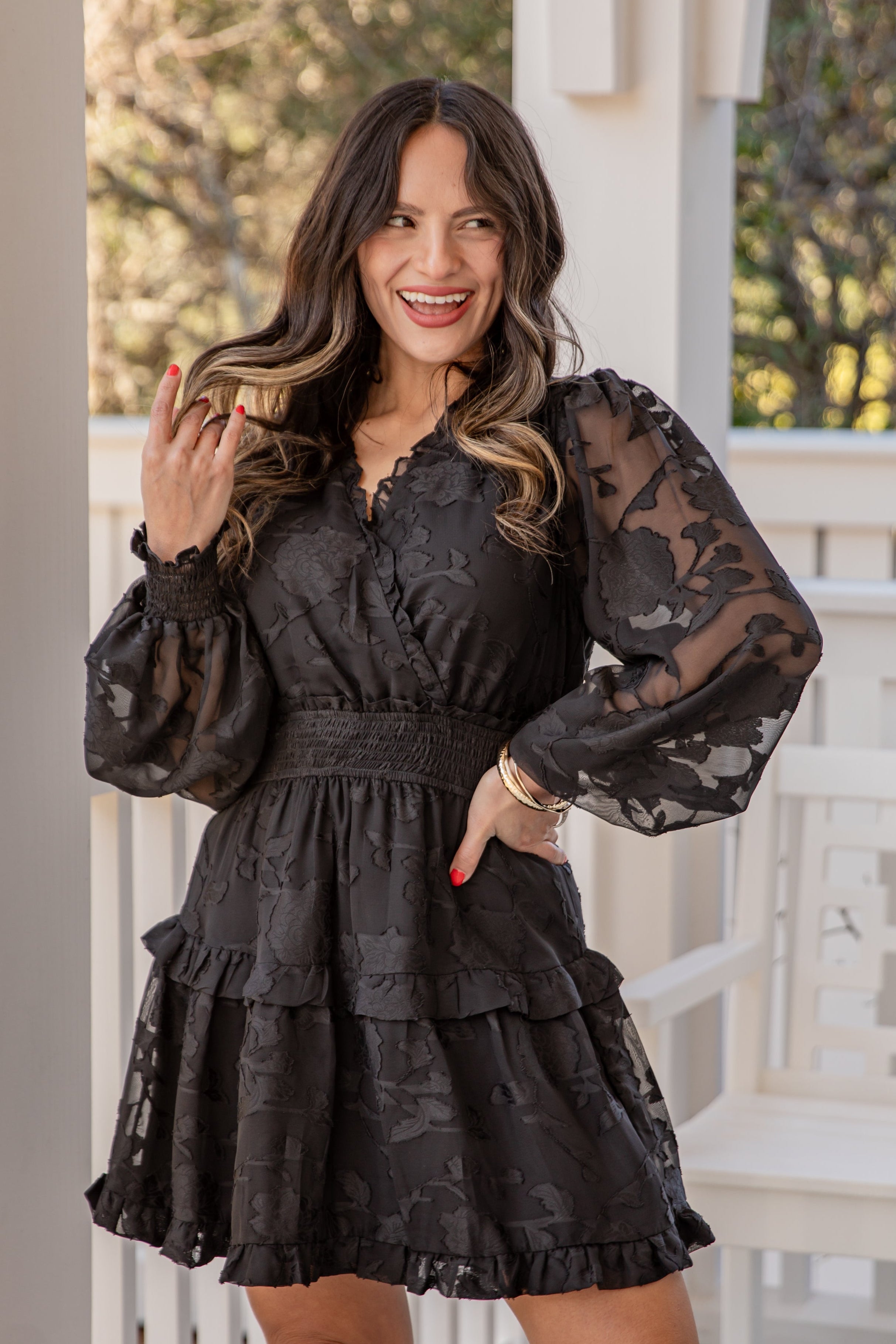 Woman wearing a black lace dress on a porch