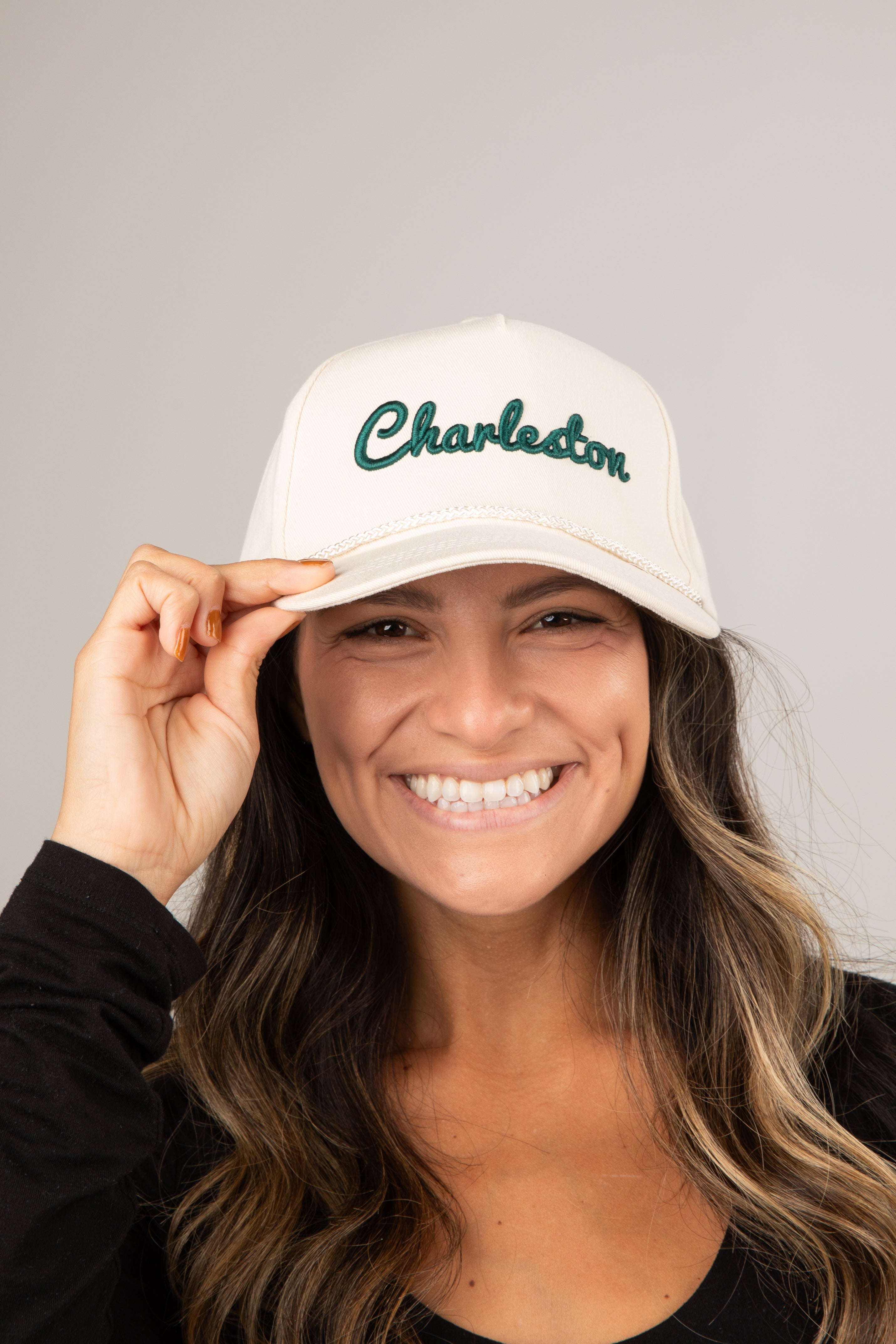 Woman wearing a white cap with &