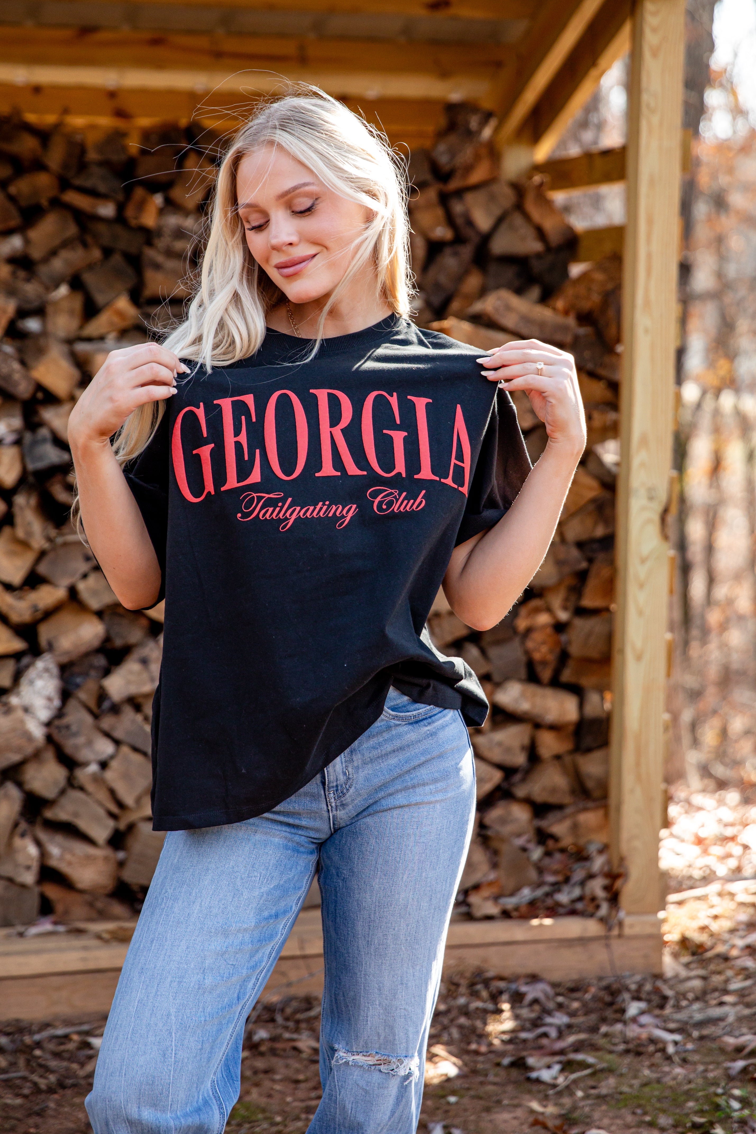Woman holding a black t-shirt with &