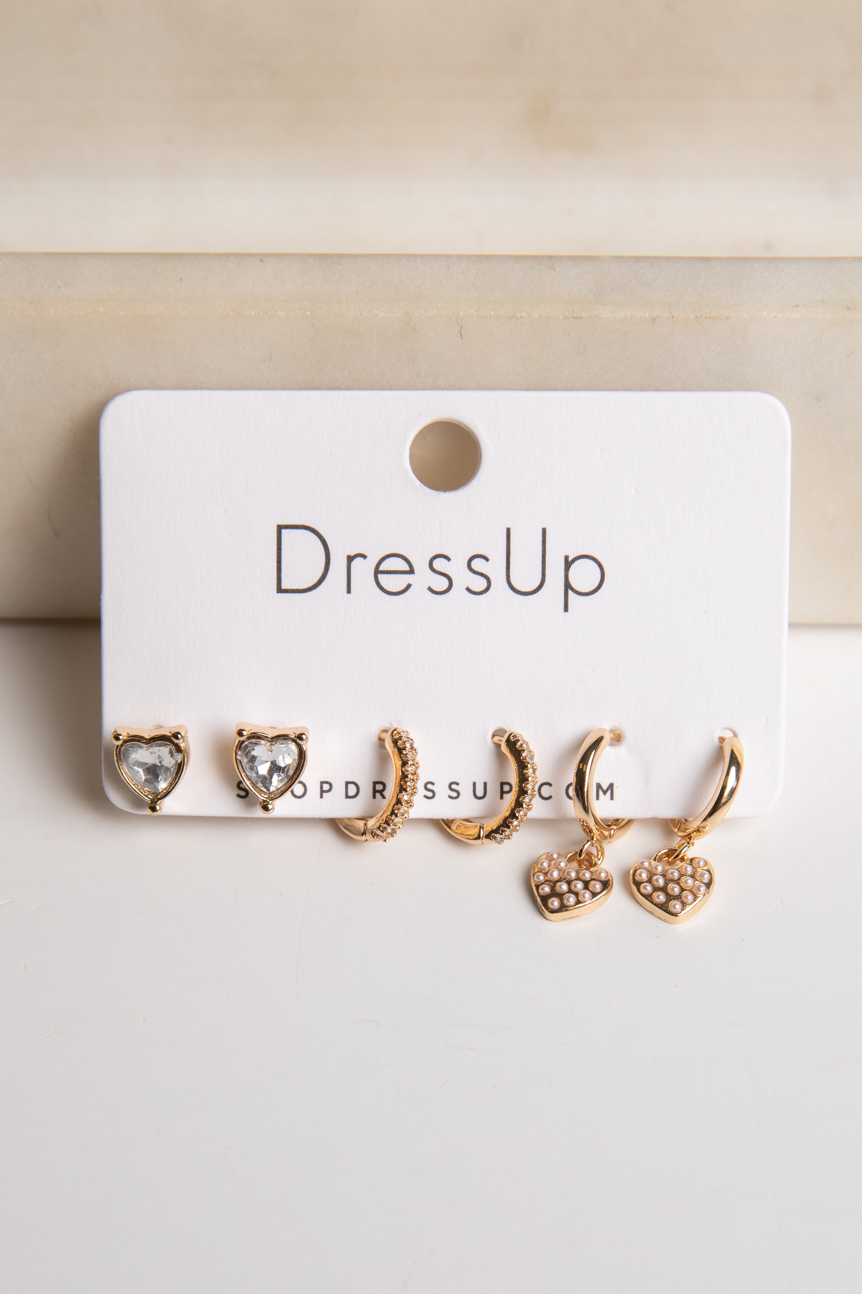 Set of gold earrings on a &