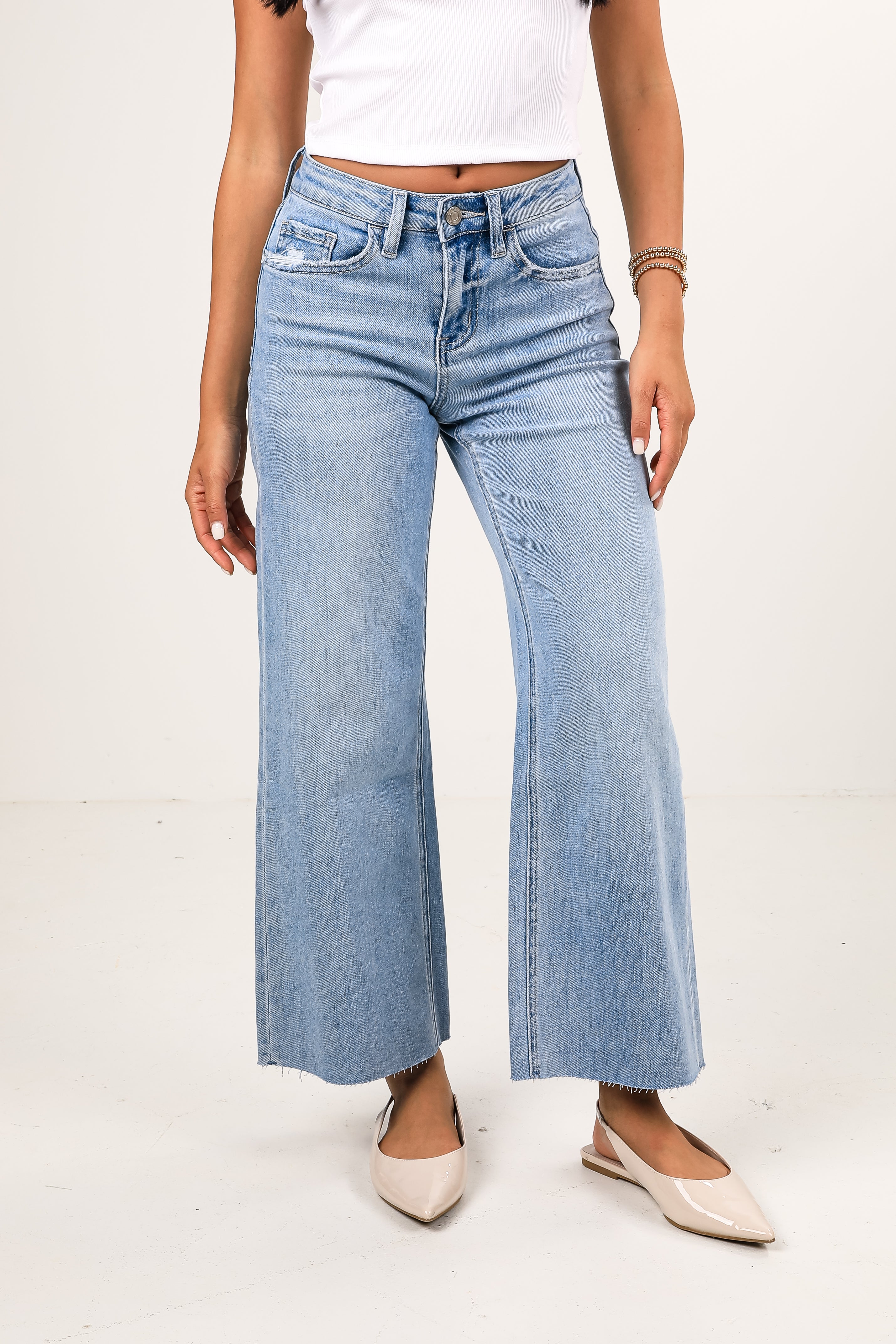 Light blue wide-leg jeans worn by a person on a white background