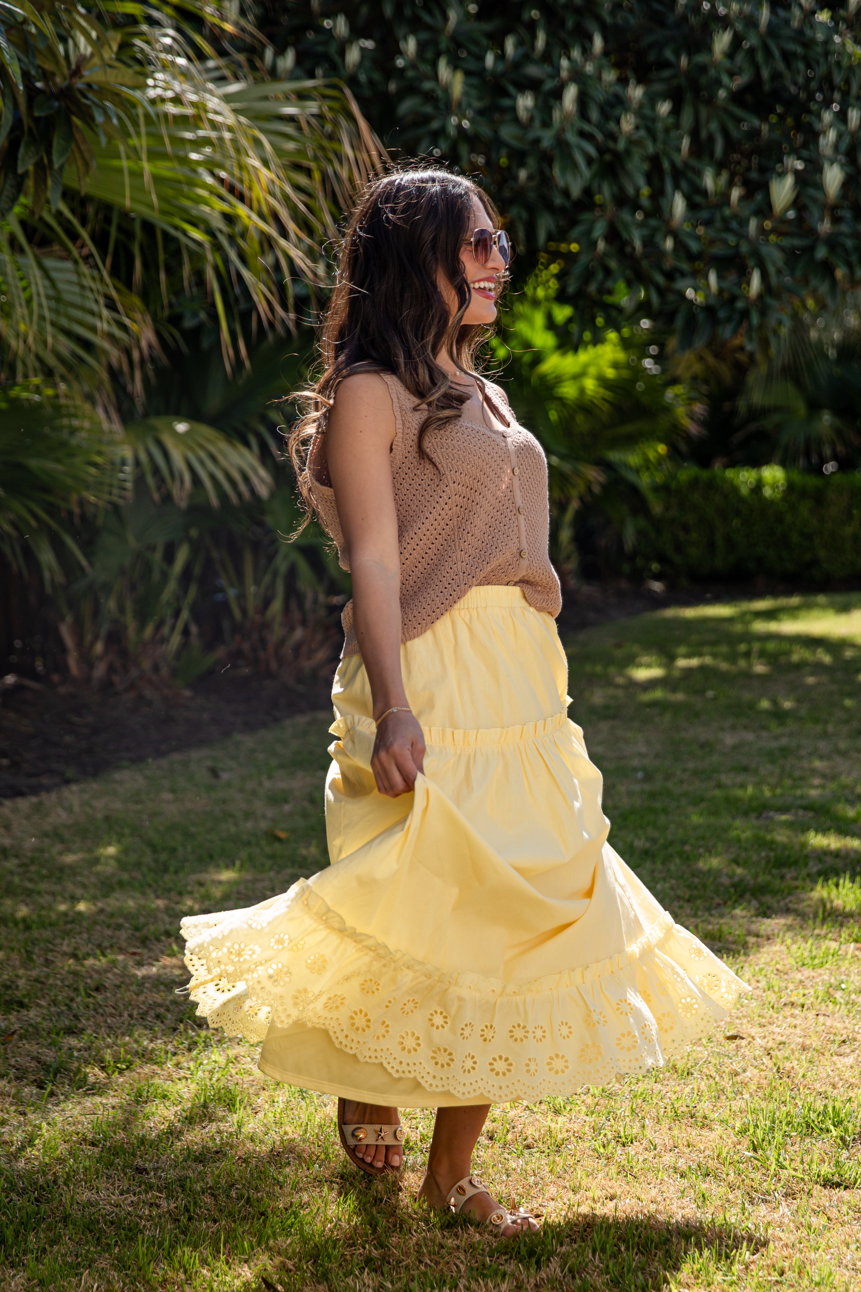 Yellow flowy maxi skirt twirling in sun