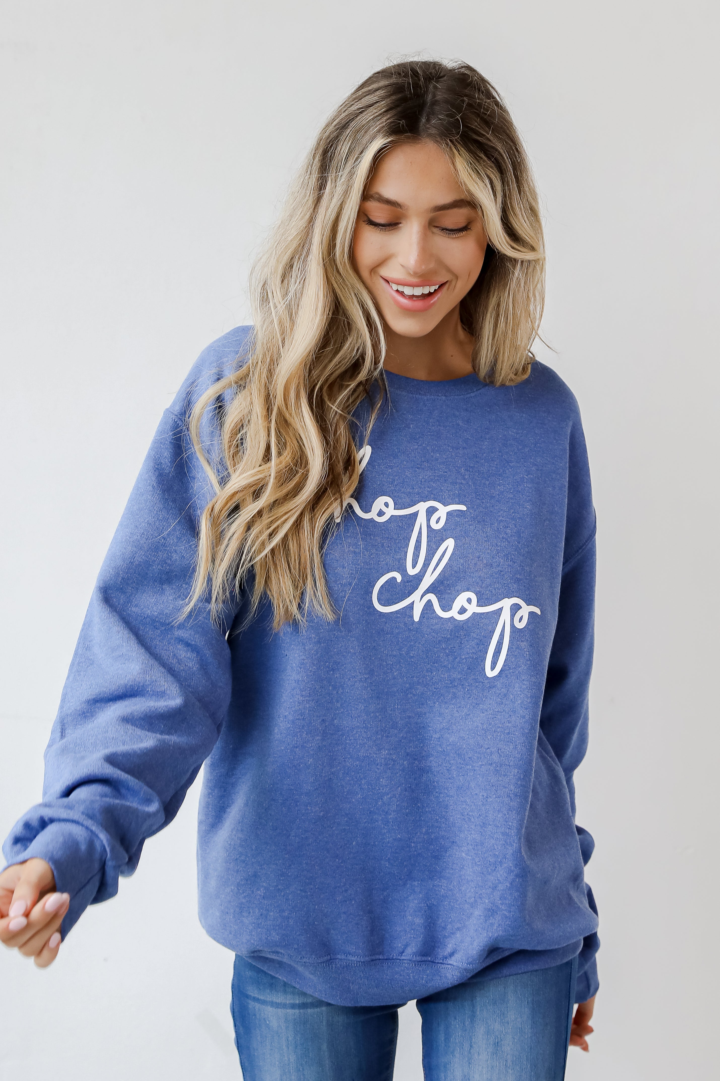This comfy sweatshirt is designed with a soft and stretchy knit with a fleece interior. It features a crew neckline, long sleeves, a relaxed fit, and the words "Chop Chop" on the front.