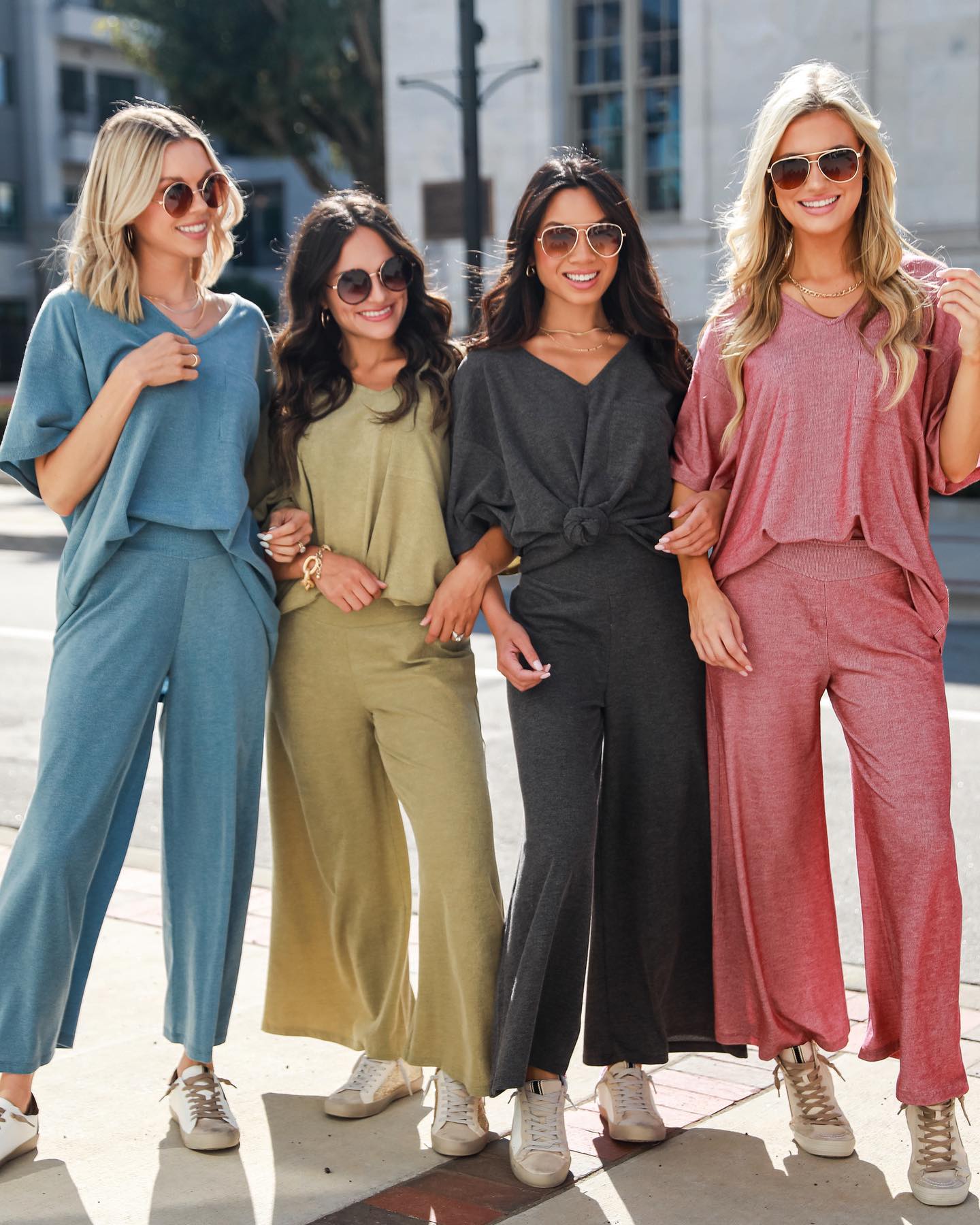 4 Ruby White Wear models wearing matching sets in various colors