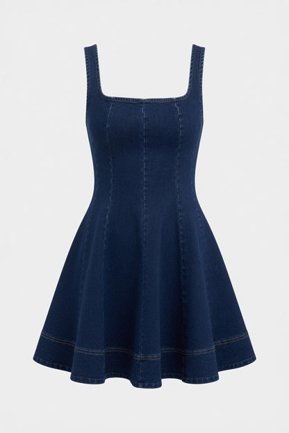 A dark blue denim A-line mini dress with a square neckline and wide shoulder straps, shown against a plain light gray background.