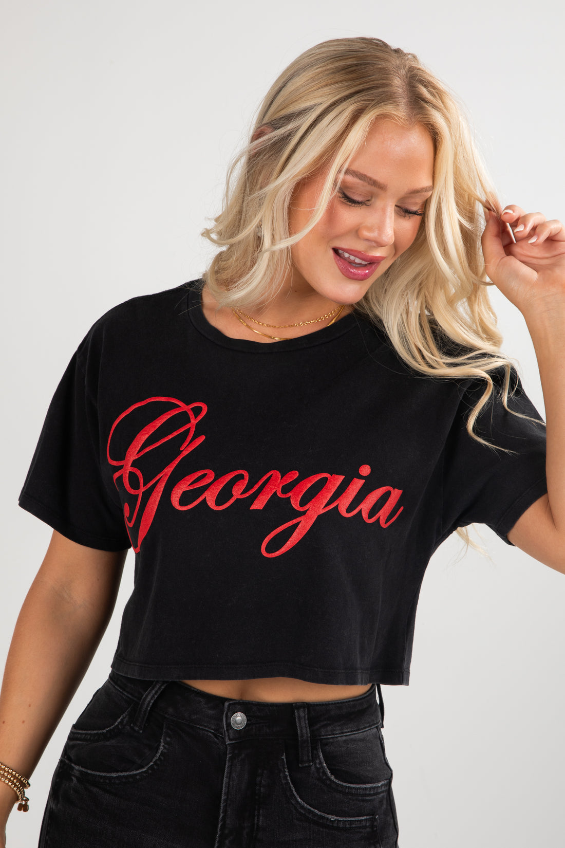 Woman wearing a black crop top with &