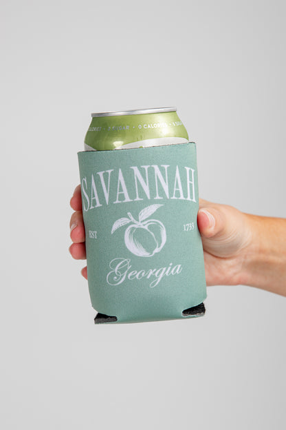 Hand holding a can with a &