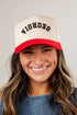 Person wearing a beige and red cap with &