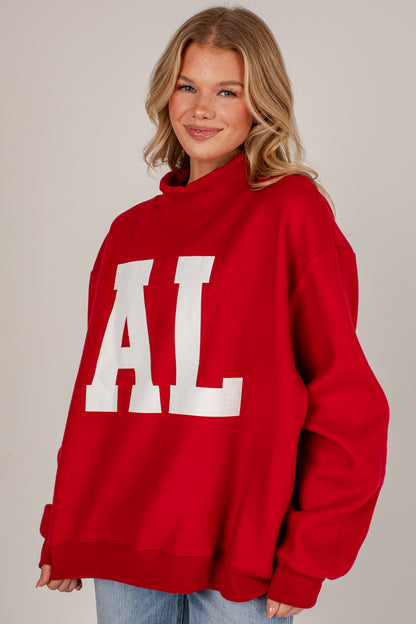 A woman wearing a red oversized sweatshirt with large white block letters &