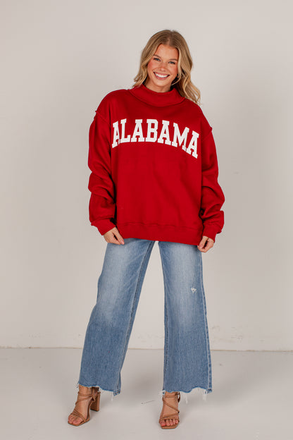 A woman modeling a red sweatshirt with &
