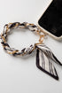 Phone case with a black and white striped scarf accessory on a white background