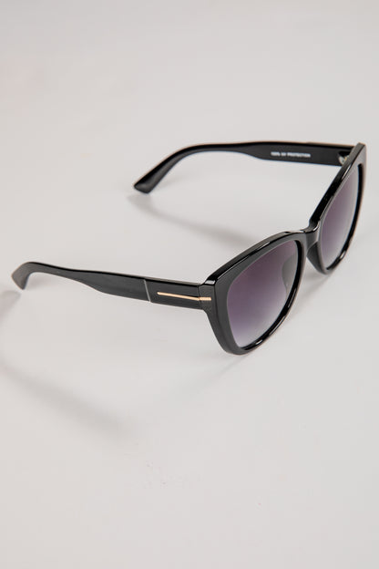 Black sunglasses with a gold accent on a white background