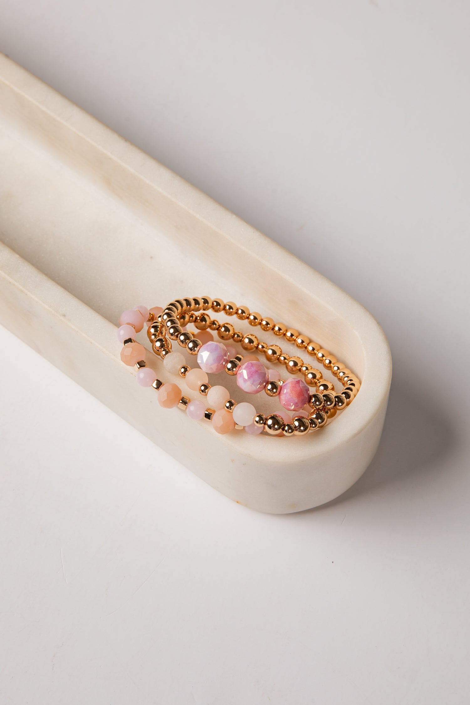 Set of beaded bracelets on a white surface