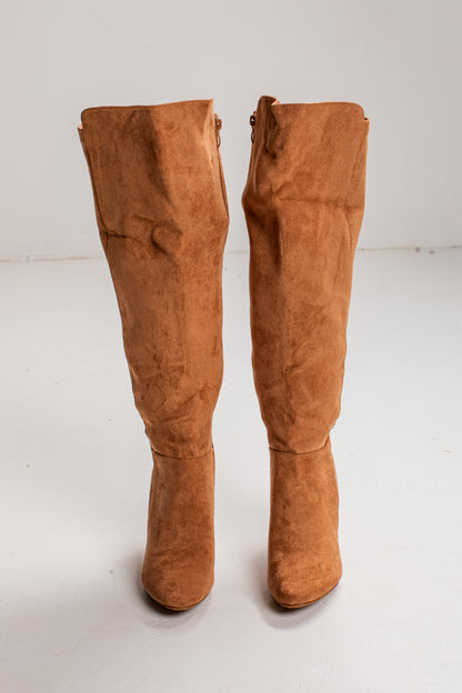 A pair of knee-high suede boots in a warm camel brown color, photographed from the front against a plain white studio background.