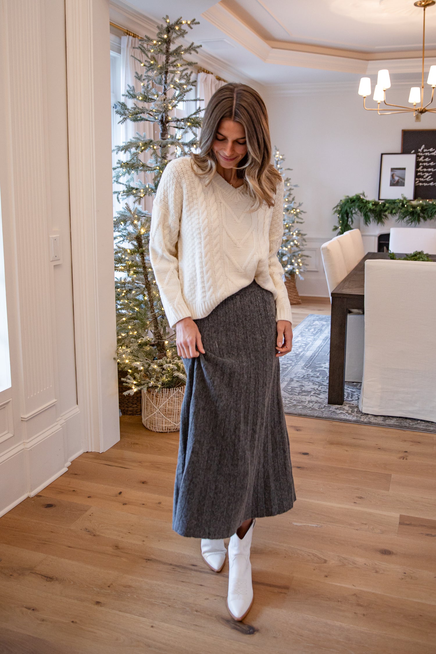 Woman in a cozy living room with Christmas decorations
