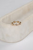 Gold ring with small diamonds on a marble surface