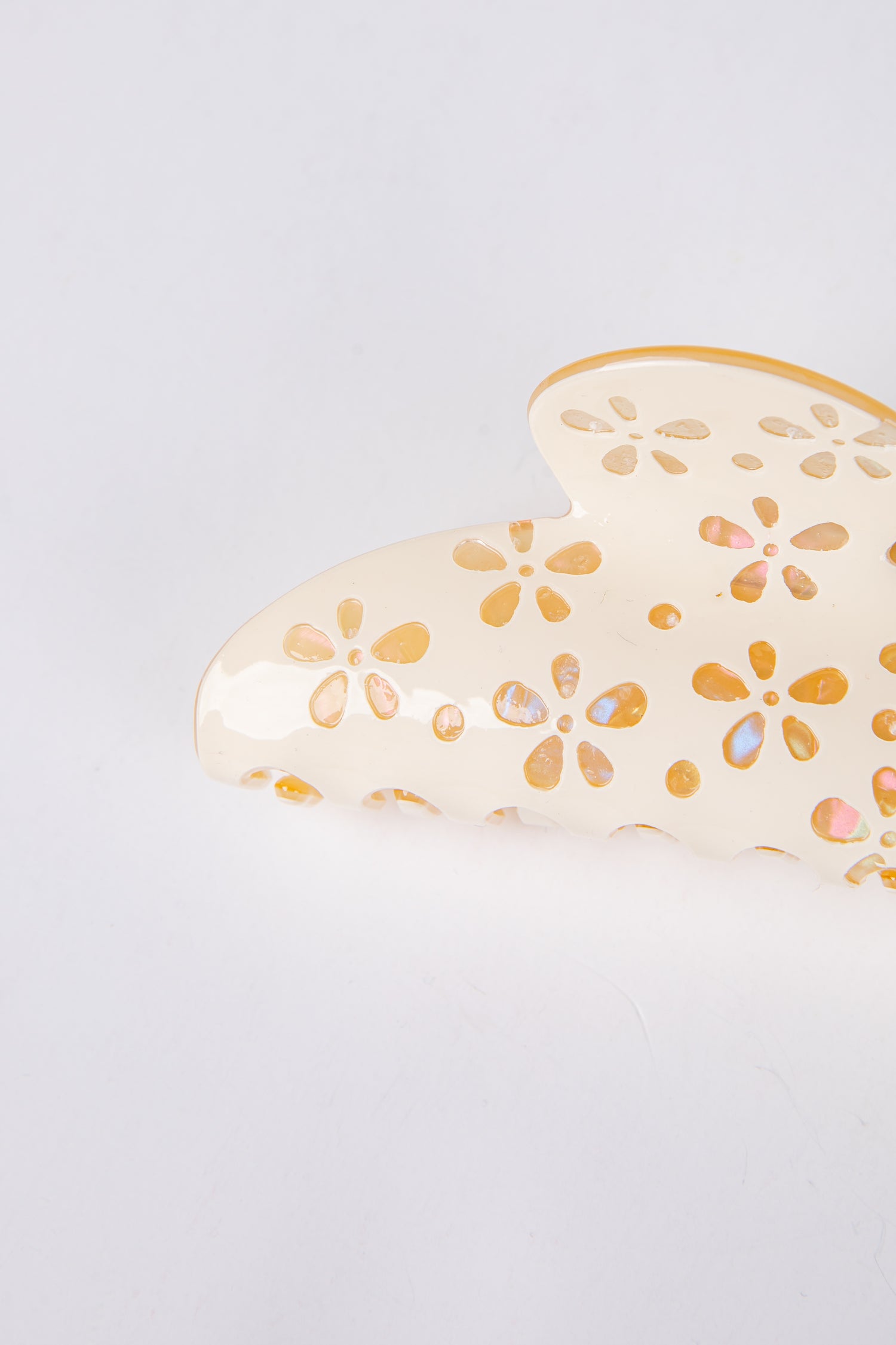 Heart-shaped claw clip with floral patterns on a light gray background