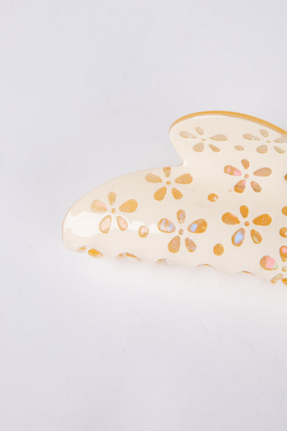 Heart-shaped claw clip with floral patterns on a light gray background