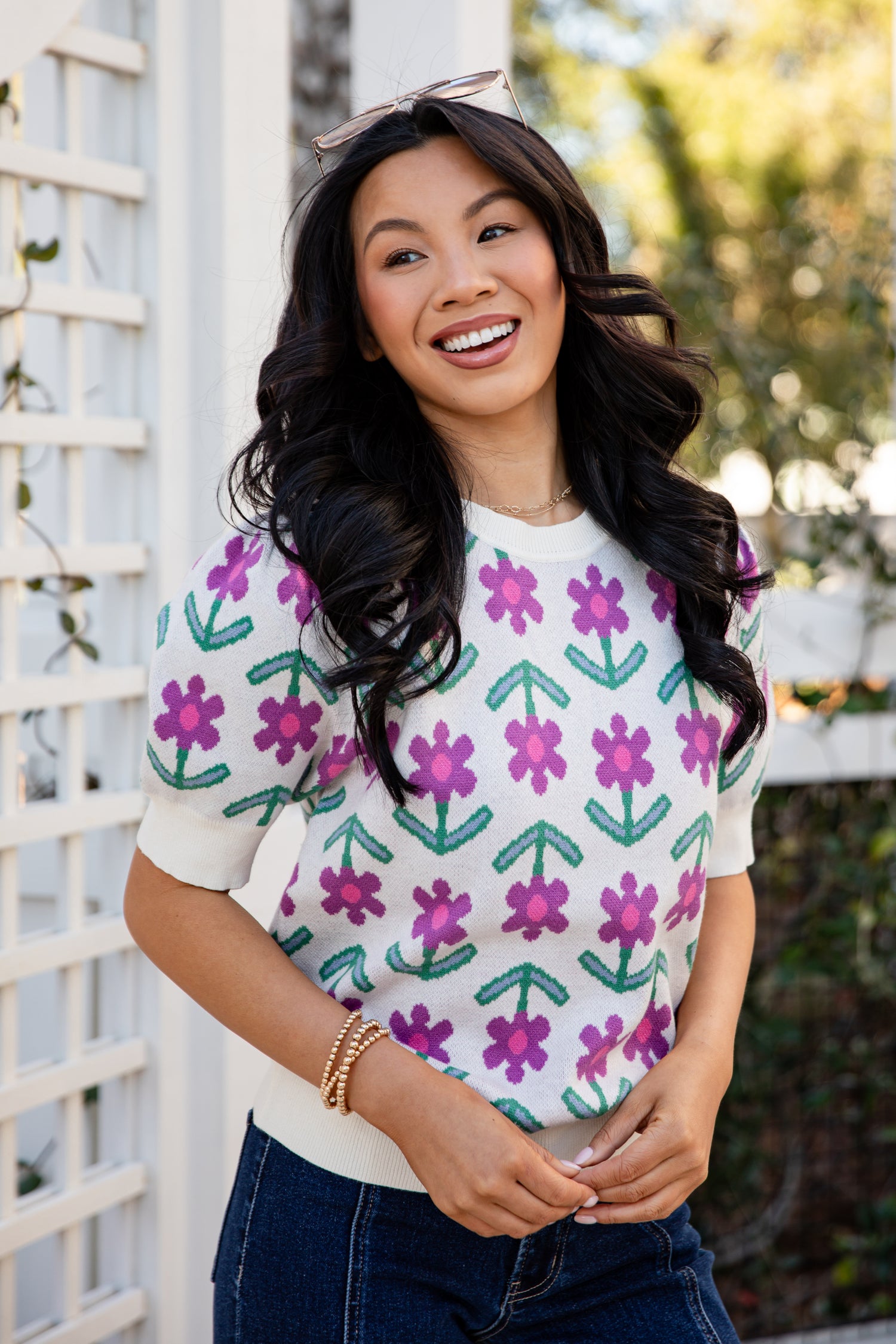 Woman wearing a colorful floral-patterned shirt outdoors