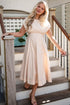 Woman in a white dress standing on a staircase