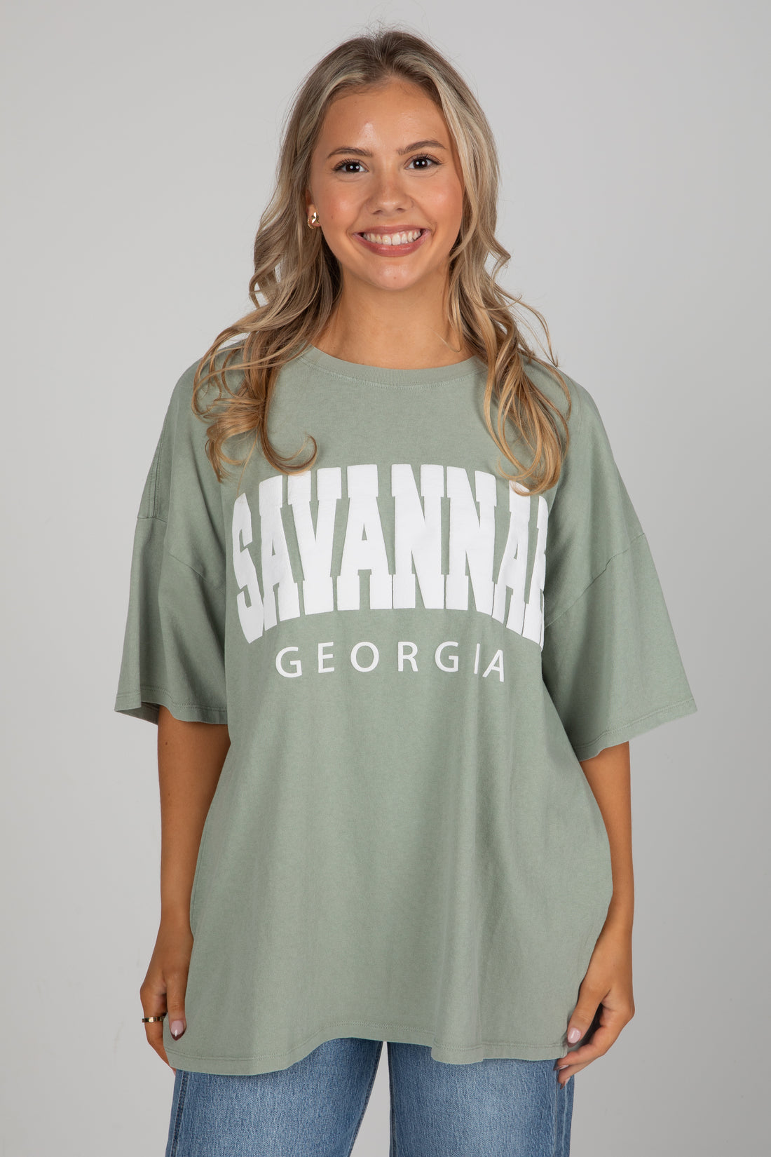 Woman wearing a green t-shirt with &