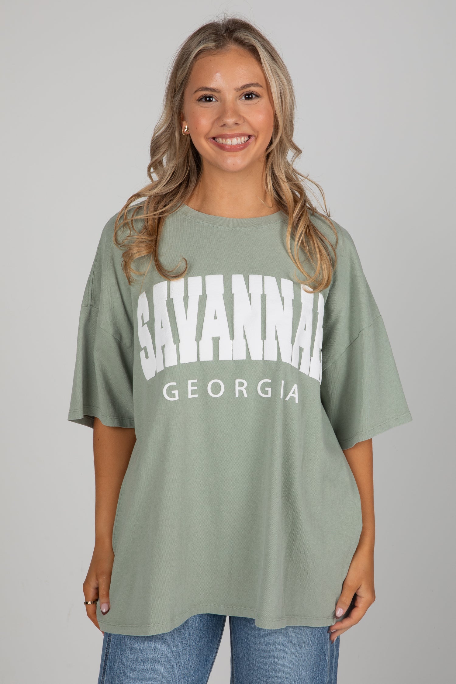 Woman wearing a green t-shirt with &