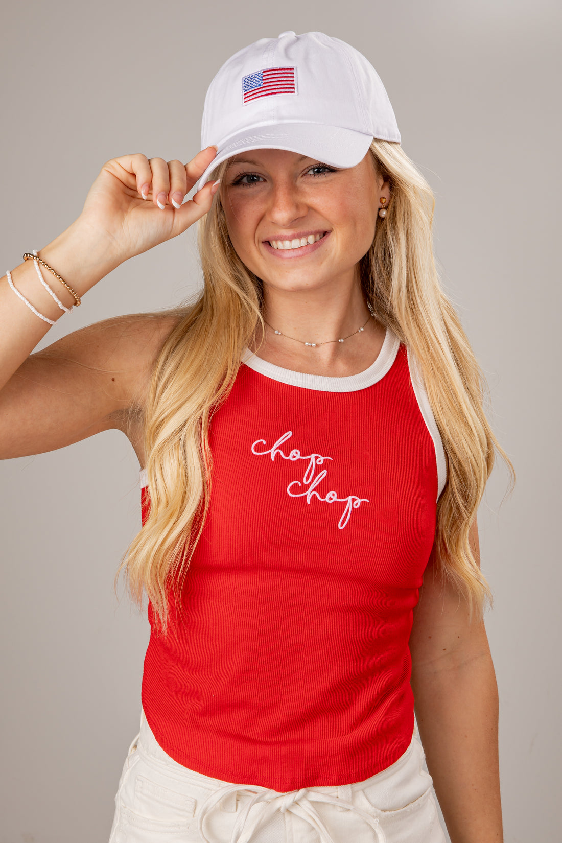 Woman wearing a red tank top with &