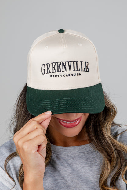 Person wearing a cap with &