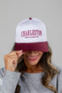 Person wearing a white and burgundy cap with &