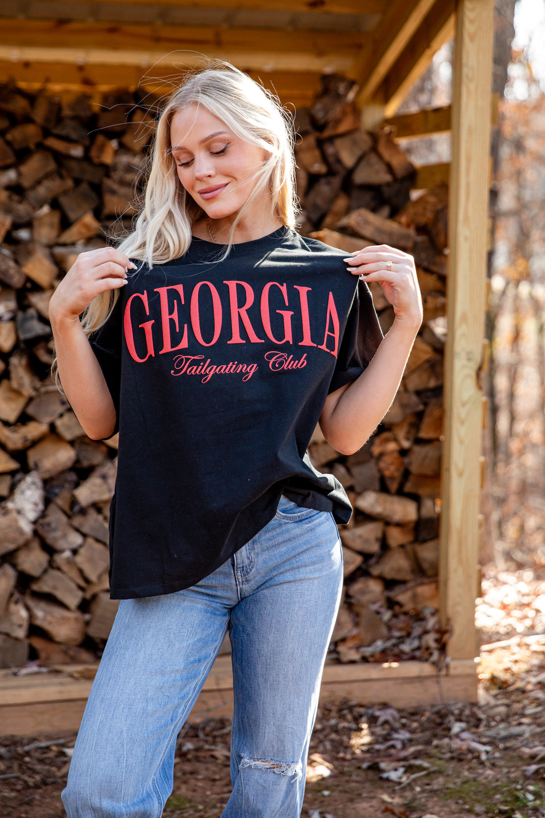 Woman holding a black t-shirt with &