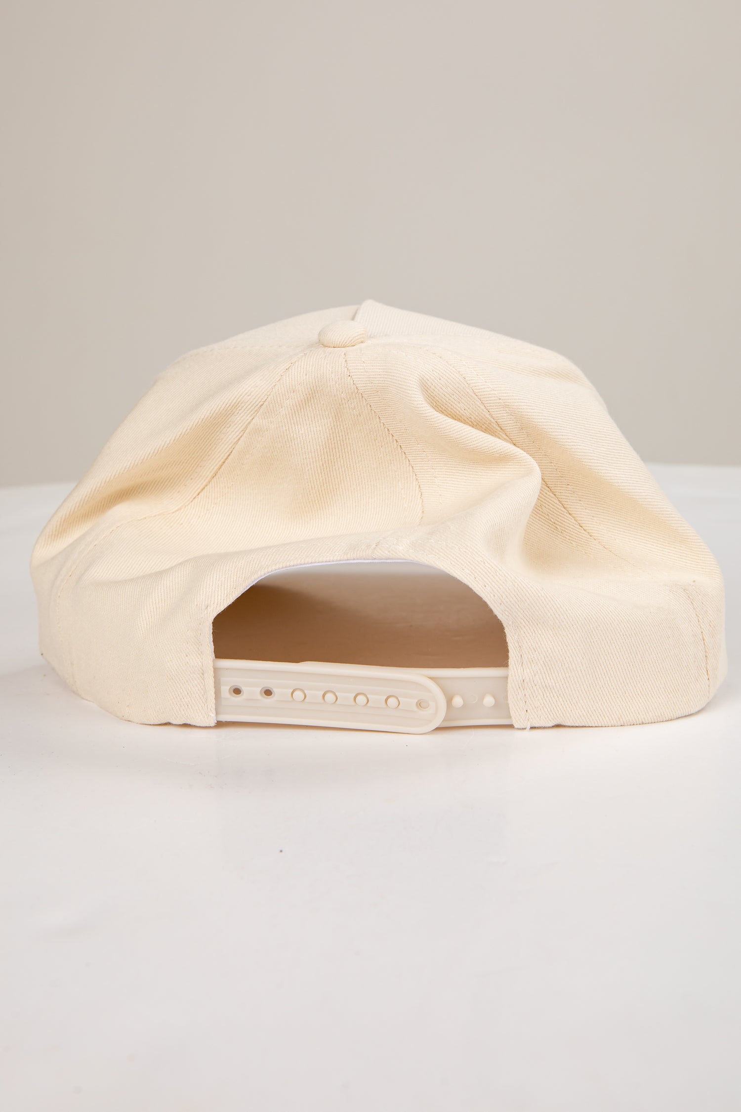 Beige cap on a light gray background