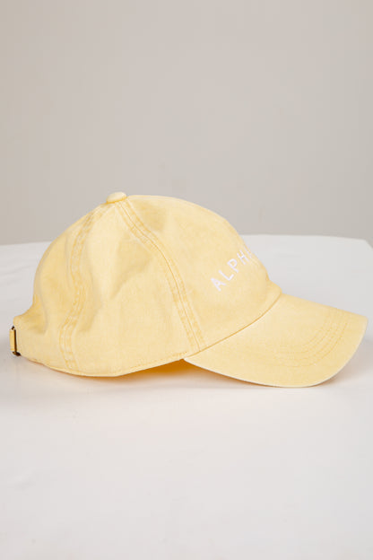 Yellow cap on a white surface with a light gray background