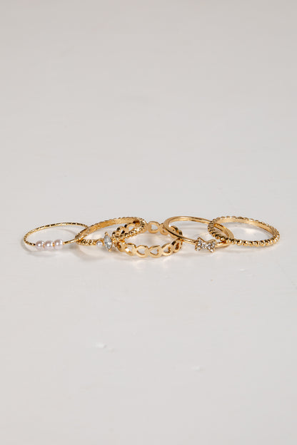 Set of gold rings on a light gray background