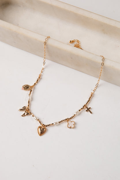 Gold necklace with heart-shaped charms on a light background