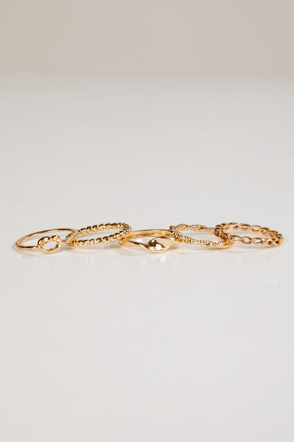 Set of gold rings on a light gray background