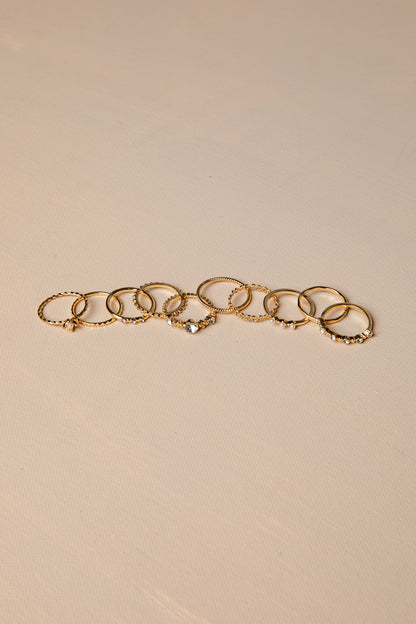 Gold rings with multiple rings on a beige background