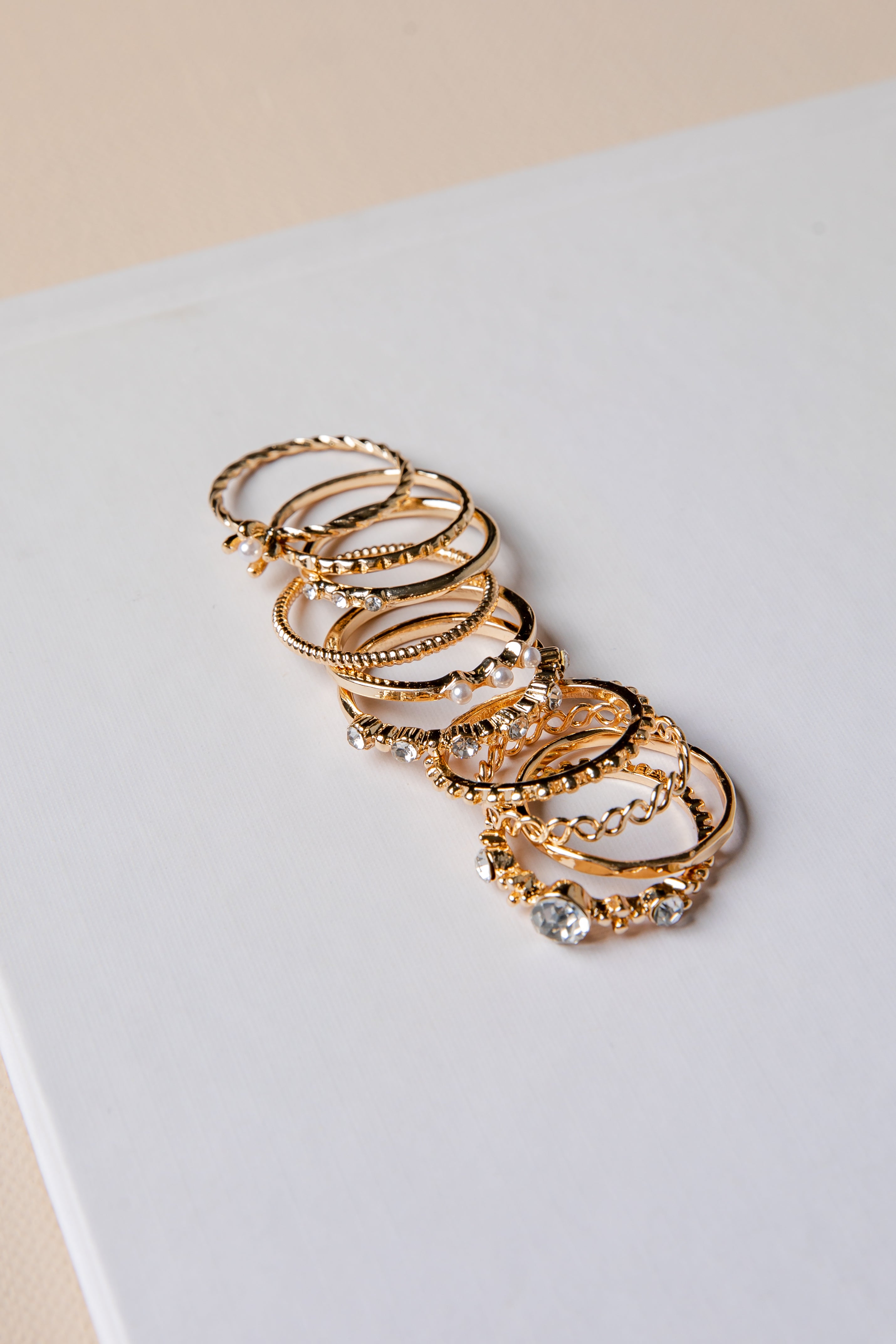Set of gold hoop earrings on a light gray surface