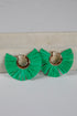 Green ruffled earrings with gold hoop centers on a light gray background