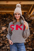 Woman wearing a sweater with &