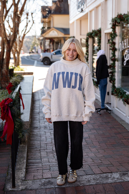 Person wearing a white sweatshirt with &