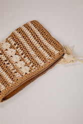 Woven clutch bag with star pattern on a light background