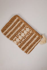 Knitted pouch with a tassel on a light gray background
