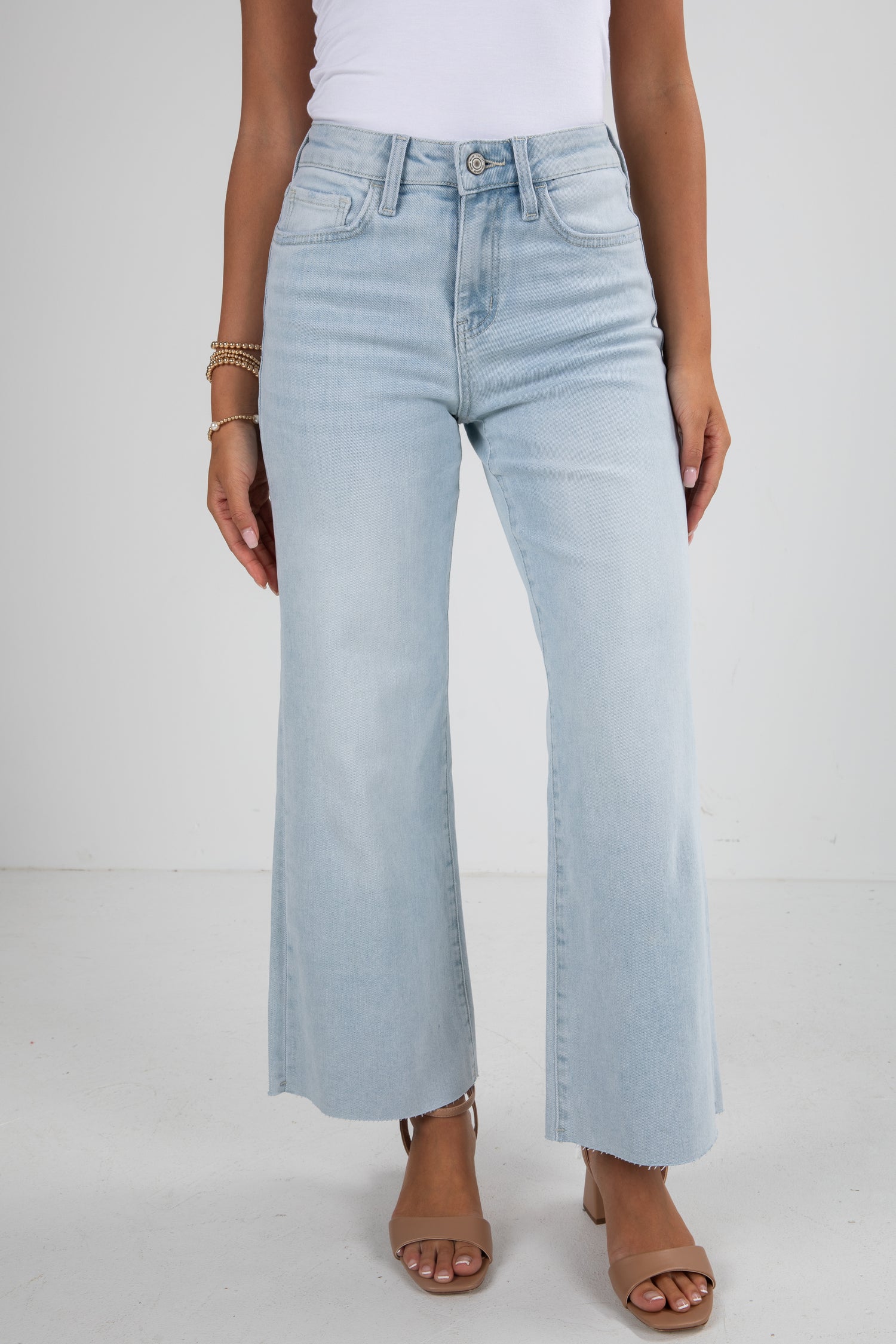 Light blue jeans worn by a person on a white background