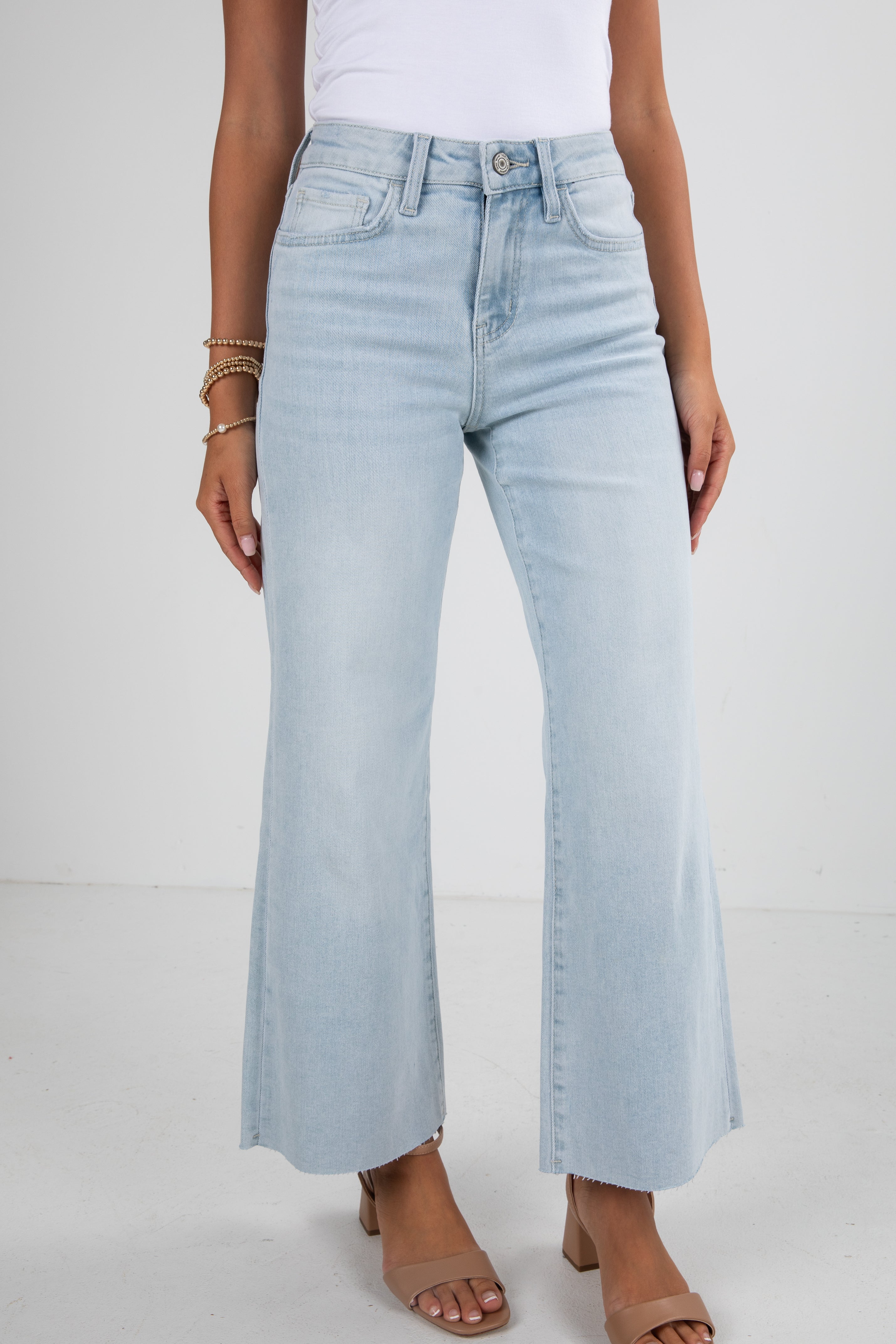 Light blue jeans worn by a person on a white background