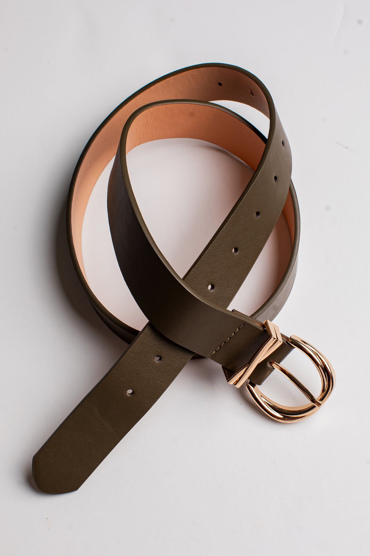 An olive green leather belt with a gold-tone metal buckle, coiled on a light gray background.