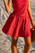 Person wearing a red dress on a sandy beach