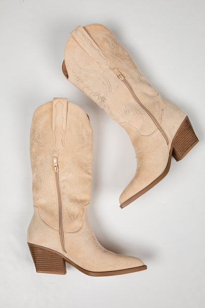 A pair of beige western-style boots with pointed toes, stacked block heels, and side zippers, displayed on a light gray background.