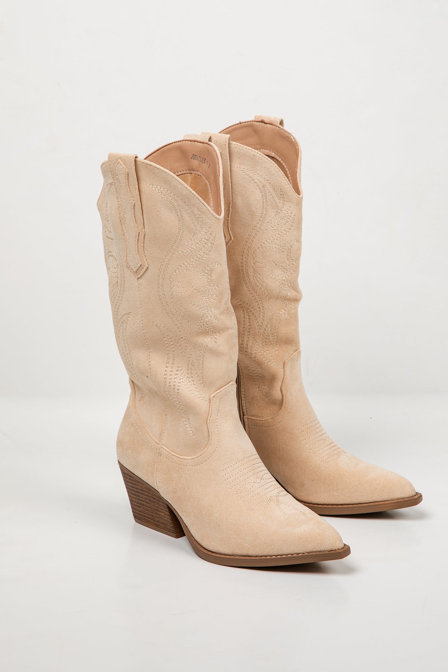 A pair of light beige faux-croc leather cowboy boots with pointed toes and low block heels, shown on a white studio background.