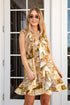 Woman wearing a patterned dress standing in front of a glass door.